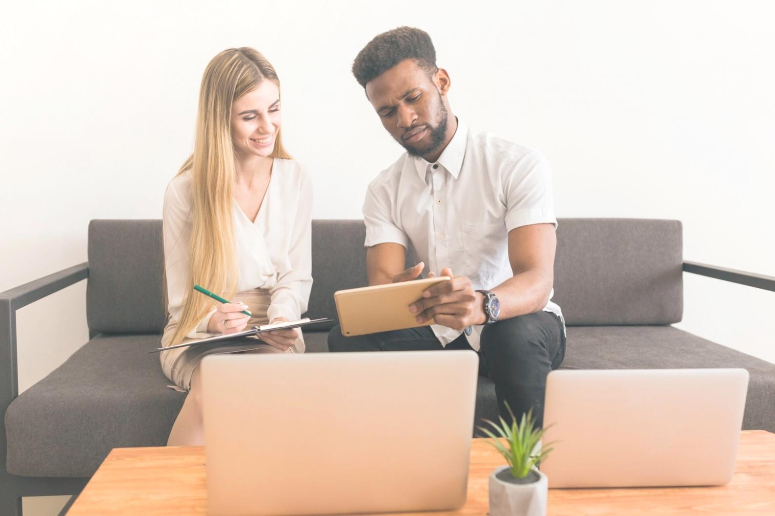 Business professionals analyzing financial data and charts on computer screens